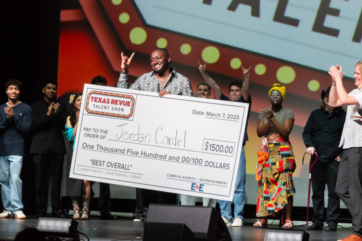 Jordan Cordel, winner of this year’s Texas Revue talent show, accepts his $1,500 grand prize for his performance of his original song “Lonely” on March 7, 2025. Cordel, a master’s student raised in Port Arthur, Texas, was among 15 student acts who performed at Texas Revue, UT’s oldest running talent show which has been held annually for over 100 years.