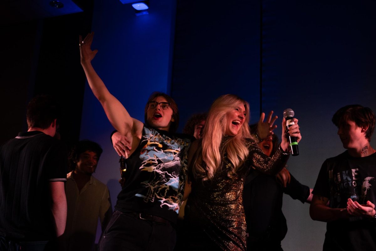 Camille Stites and her guitarist hold one another in celebration after winning Battle of the Bands on March 11, 2025. Camille is now set to perform at Forty Acres Fest's day show on March 29.