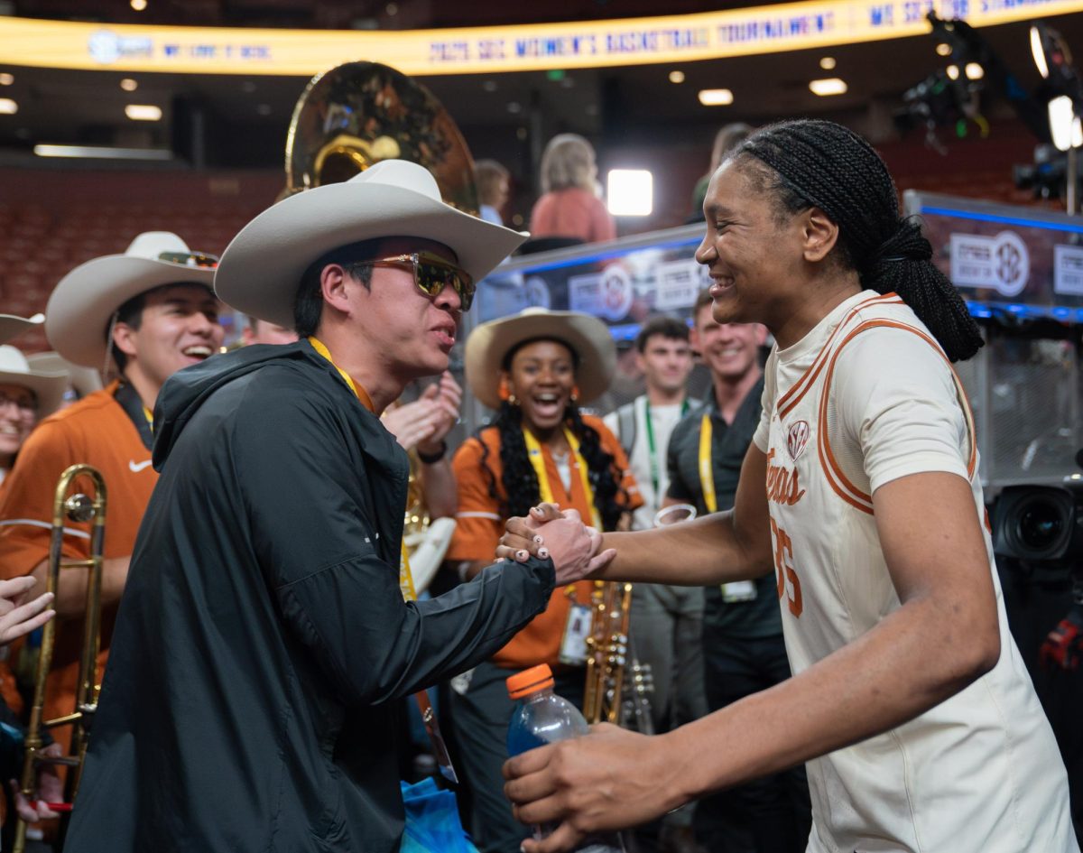 Sophomore Madison Booker celebrates with the Longhorn Pep Band after winning against LSU on March 8, 2025. 