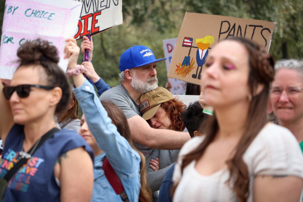 Participants of the rally for women's and LGBTQ+ rights embracing each other at the Texas Capitol on Mar. 8, 2024.