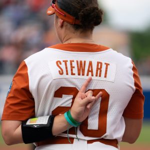Sophomore Katie Stewart stands for the national anthem with her horns up behind her back during the Women's College World Series Championship against Texas Tech on June 4, 2025.