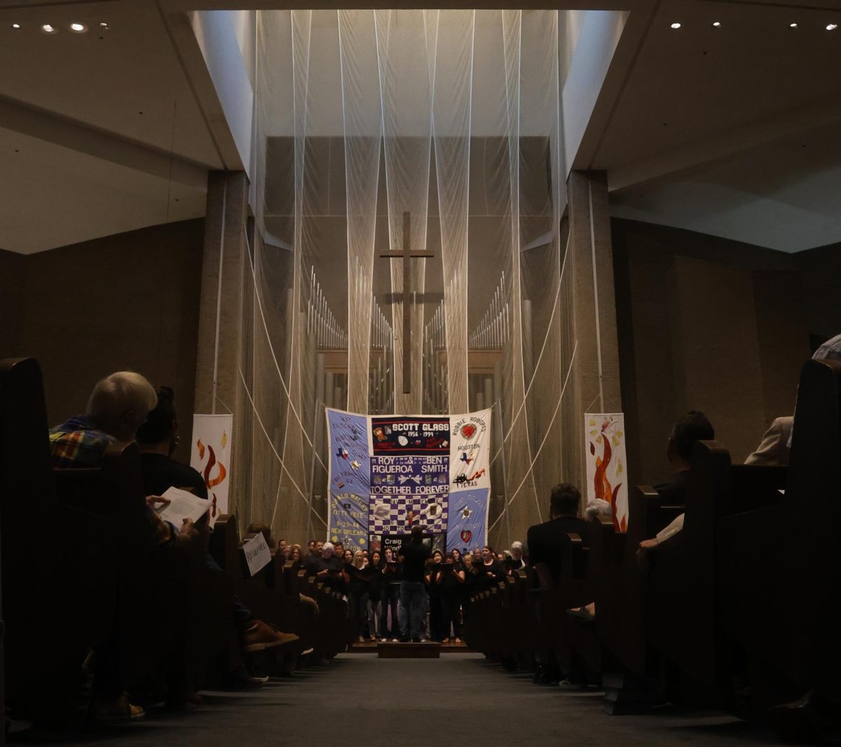 The Conspirare Symphonic Chorus sings during a memorial ceremony at the First Baptist Church of Austin on Aug. 24, 2025. The ceremony memorialized those lost to AIDS and commemorated the display of panels from the AIDS Memorial Quilt in Austin.