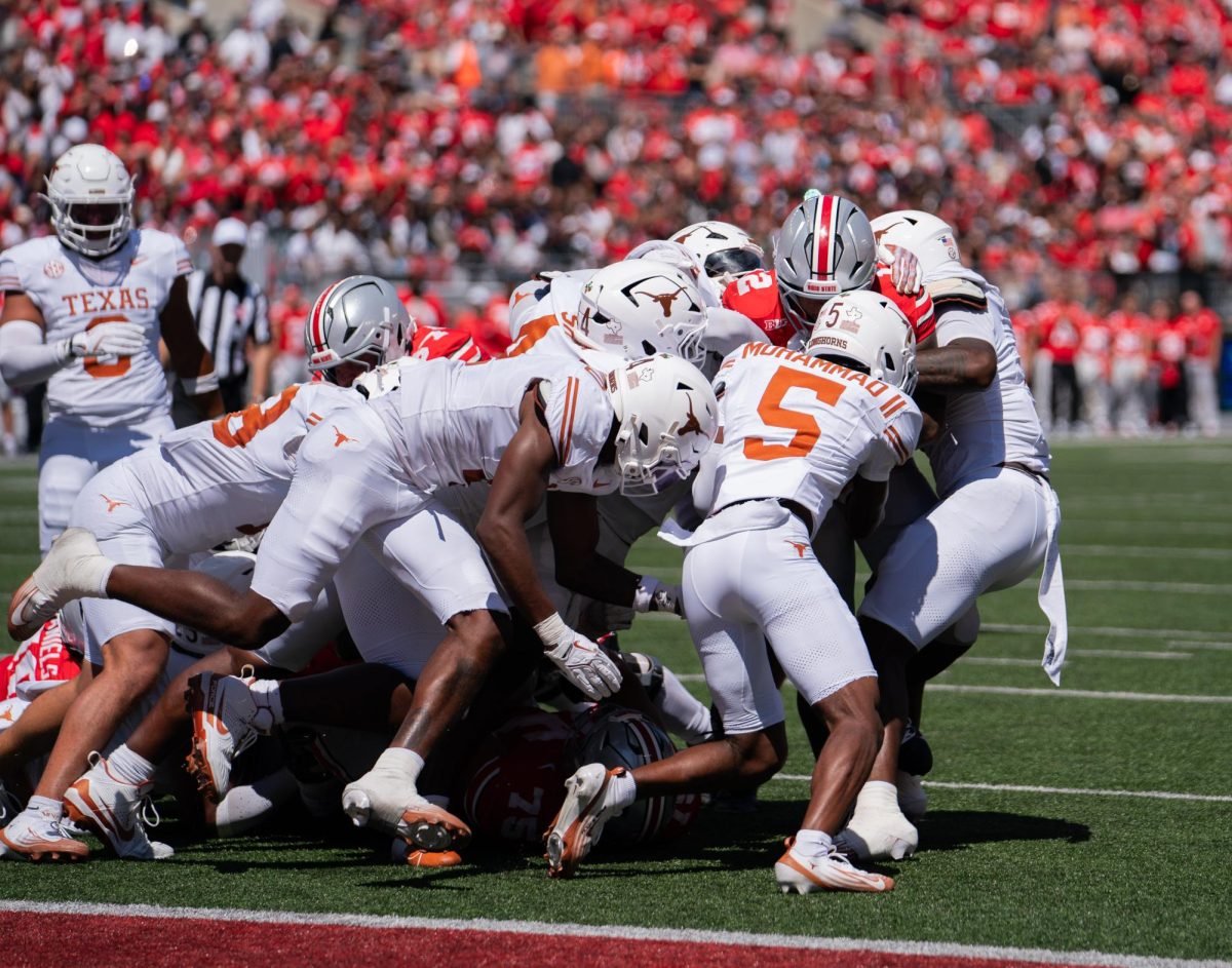 Senior CJ Donaldson Jr. gets tackled by a herd of Longhorn defenders on Aug. 30, 2025. 