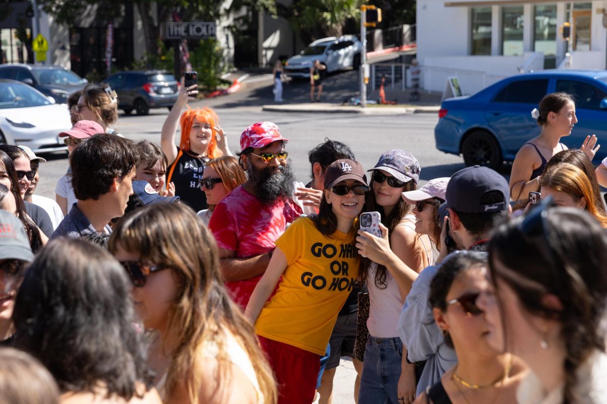 Danielle Haim poses for a picture with a fan outside Jo's Coffee on South Congress on Sept. 25, 2025. The band paid for fans' coffees. 