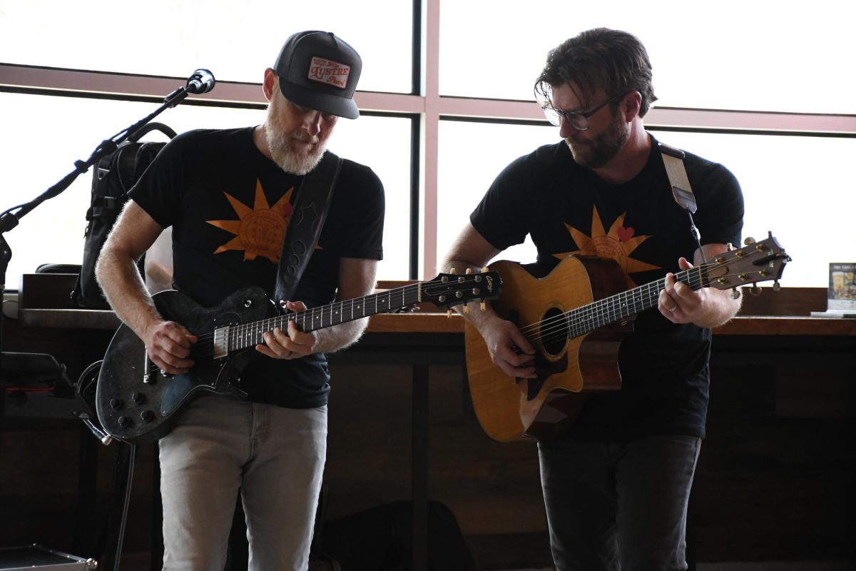 Singers Scott Clark (left) and Dave Madden (right) perform a guitar solo during their song “Probably a Lie” at HAAM Day music festival at the HEB Hancock location on Sept. 23, 2025. The duo has been working together for over 20 years.