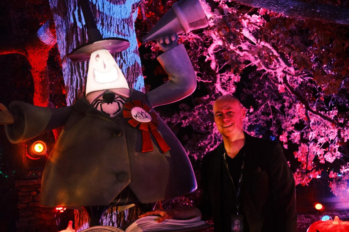 Bob Bursey, executive and artistic director of Texas Performing Arts,  stands, next to The Nightmare Before Christmas character The Mayor at The Nightmare Before Christmas light trail located at Lady Bird Johnson Wildflower Center on Sept. 24, 2025. 