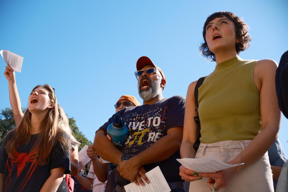 Protesters chant at a protest organized by SDS on Oct. 13 outside of the UT Tower. SDS organized the protest encouraging the University to reject the Compact for Academic Excellence proposed to the University by the Trump Administration.