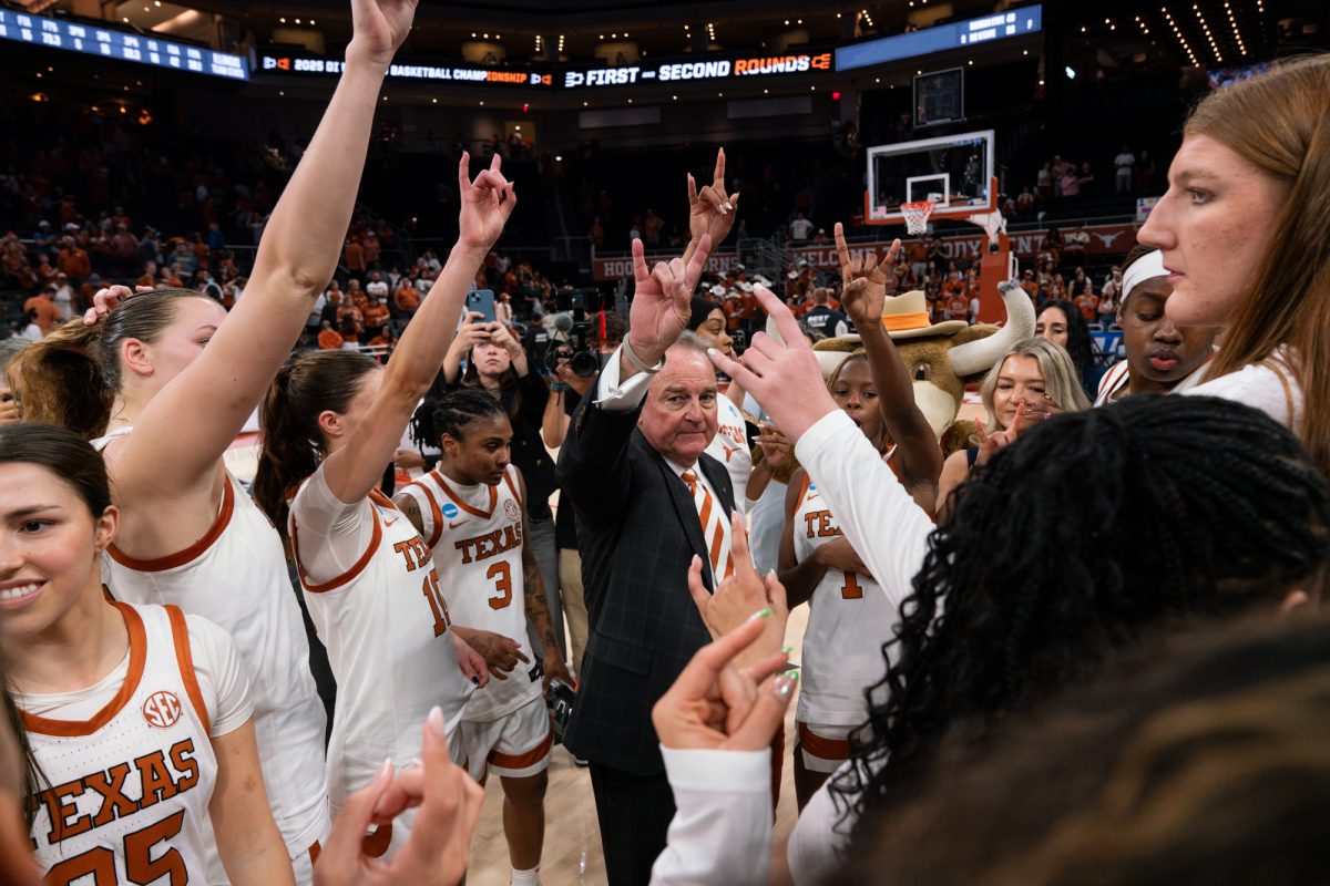 Head coach Vic Schaefer with the women's basketball team after their win against Illinois in the NCAA tournament game on March 24, 2025. 