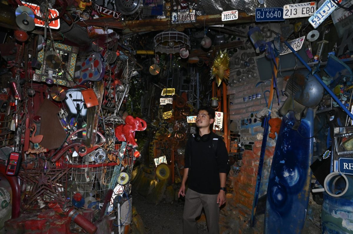 Takuma Tsugawa wanders around The Cathedral of Junk on Oct. 28, looking for ideas for his documentary project. Tsugawa is a first year MFA in Radio Television and Film at UT.
