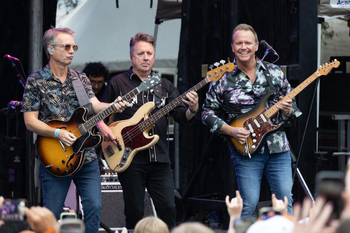From left, guitarist Brian Eichenberger, bassist Keith Hubacher and guitarist John Wedemeyer perform on the LBJ Lawn on Nov. 1. The musicians are part of The Beach Boys' touring band, which performed at the Longhorn City Limits following the Texas vs. Vanderbilt game.