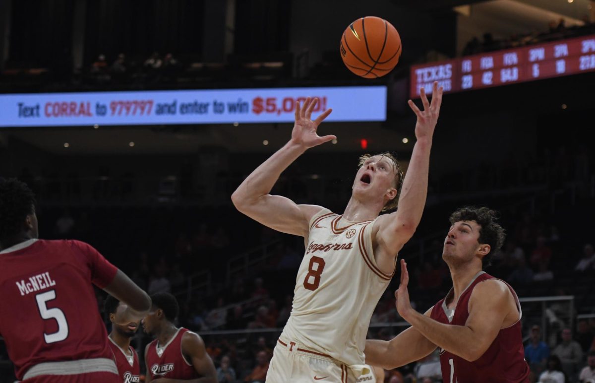 Texas sophomore Matas Vokietaitis works to keep control of the ball after a missed shot against Rider on Nov. 18.