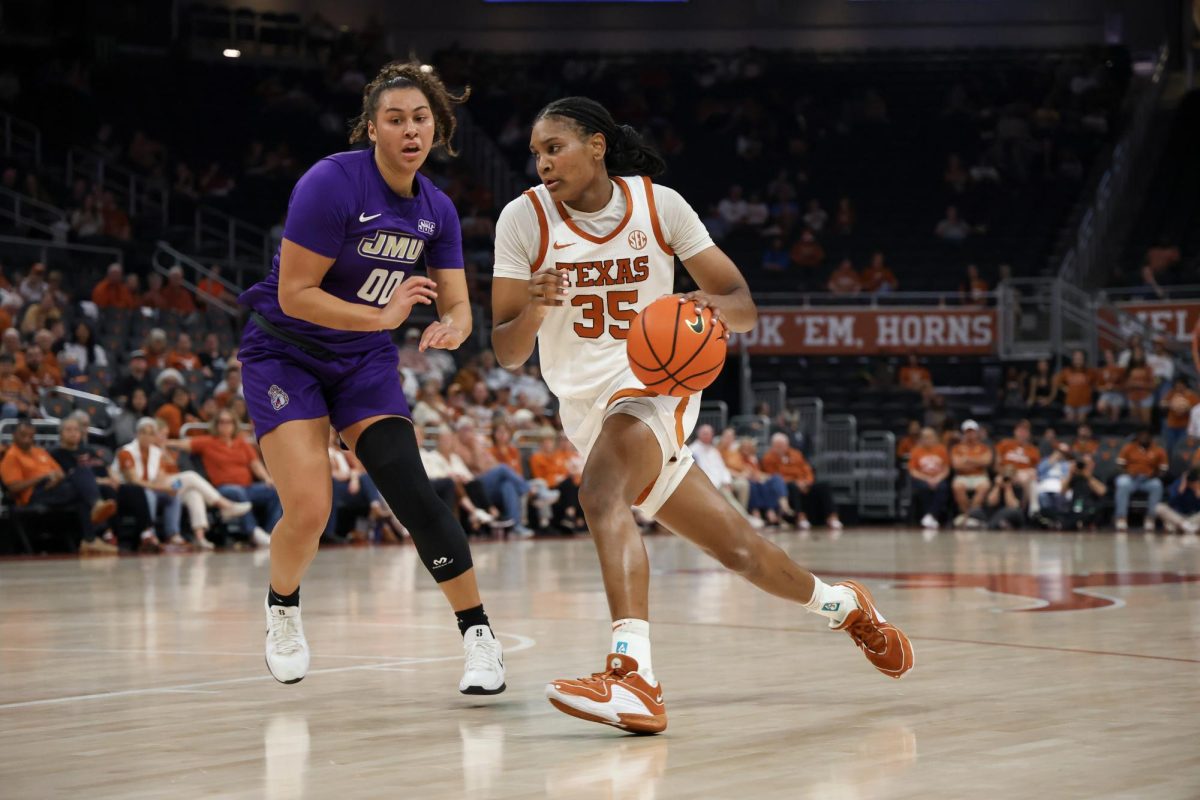 Junior forward Madison Booker dribbles the ball during Texas' game against James Madison at the Moody Center on Nov. 19.