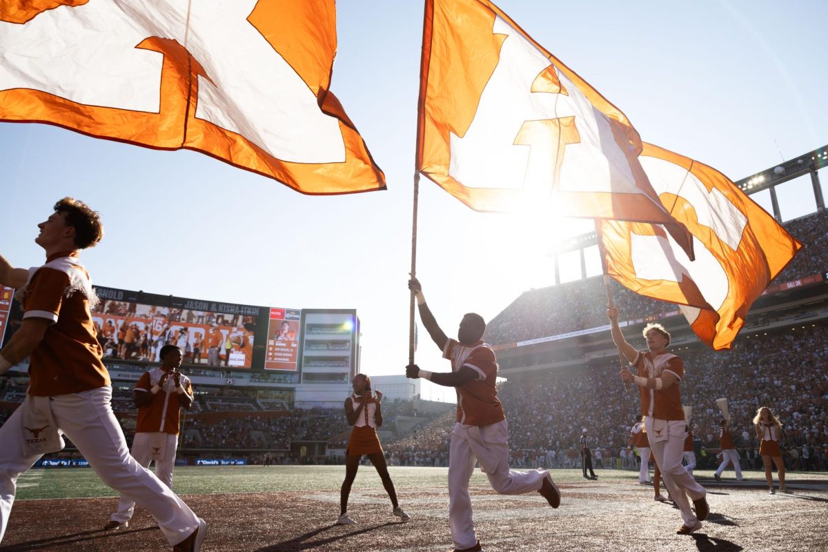 Texas Cheer runs flags across the field during the game against the Arkansas Razorbacks on Nov. 22, 2025. 