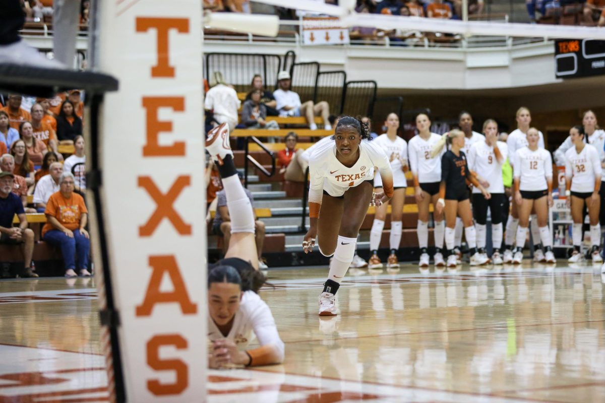 Junior Torrey Stafford watches teammate sophomore Rella Binney dive for the ball during a game against Vanderbilt at Gregory Gym on Sept. 24.