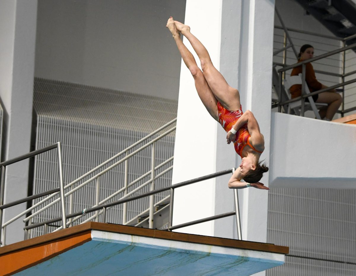 Junior Bayleigh Cranford dives off the five-meter platform on Nov. 15 at the Texas Dive Invitational.