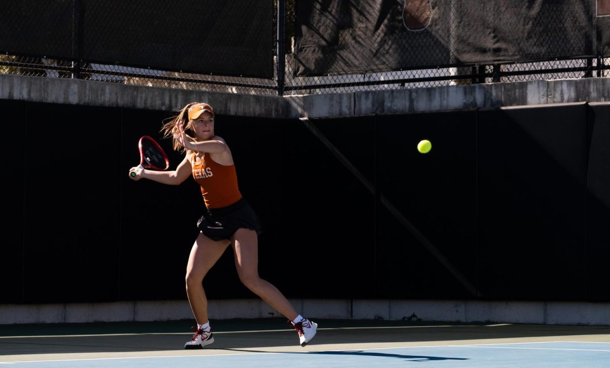 Freshman Elizabeth Ionescu hits the ball during a singles match against Pepperdine on Sunday.
