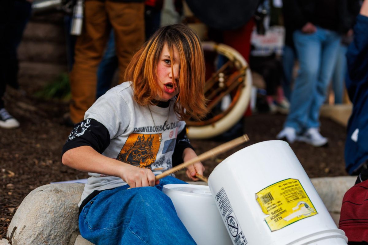 A young protestor uses drumsticks against buckets on Friday, Jan. 30.