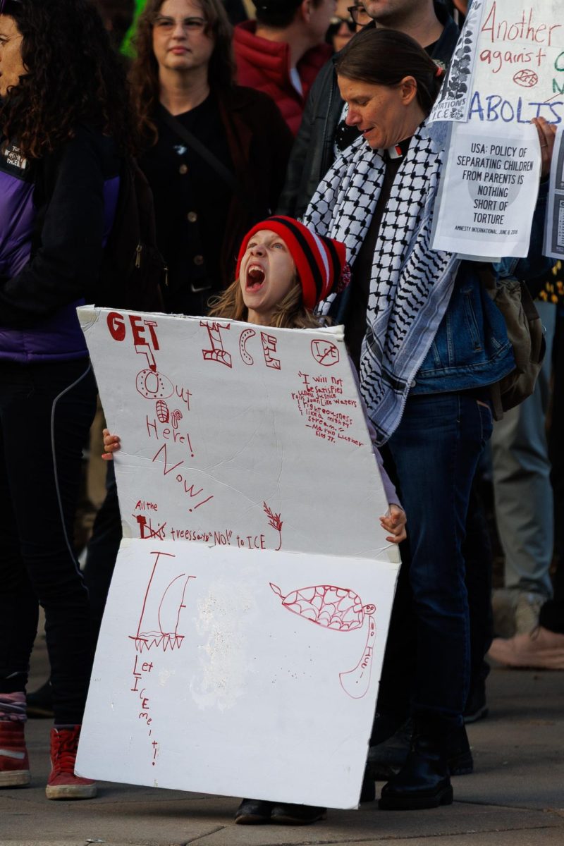 A young protestor holds up a sign on Friday, Jan. 30.