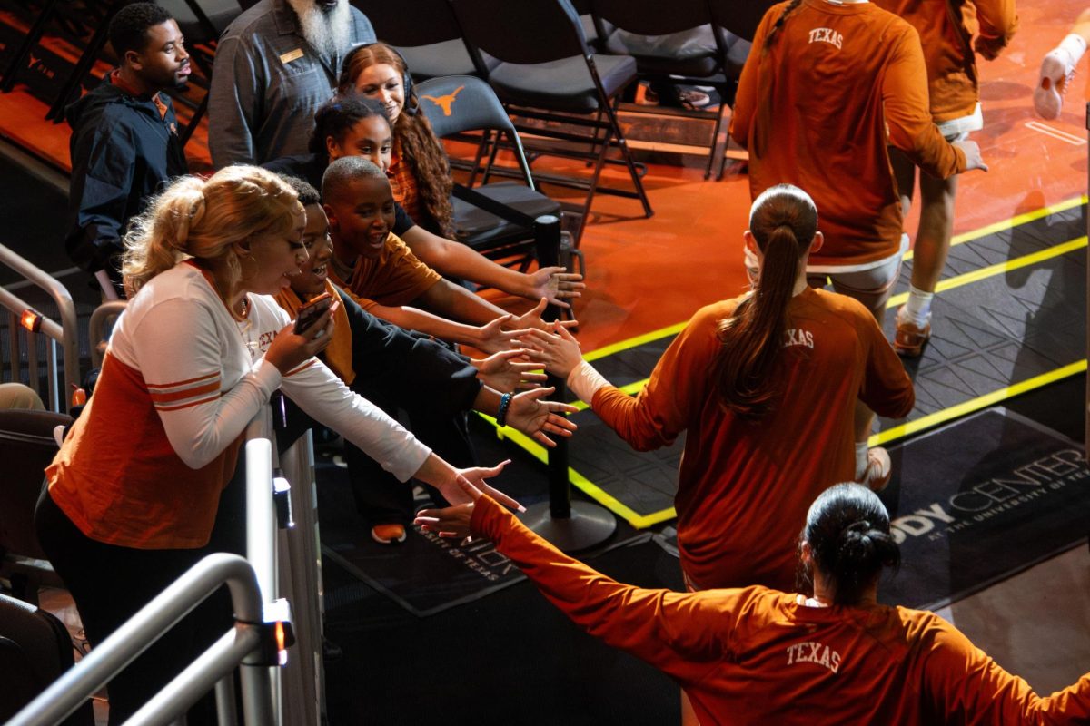 Fans high-five the Longhorns as they run out onto the court for the second half of a game against Auburn on Thursday, Jan. 8. The Longhorns went on to win the game with a final score of 97-36.