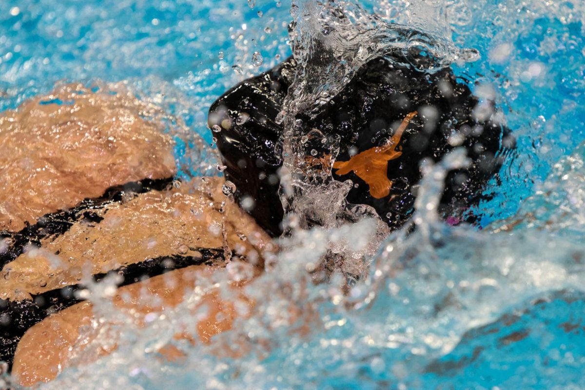 The swim cap of a Texas swimmer popping out of the water at the Texas Swim Invitational on Nov. 26, 2024.