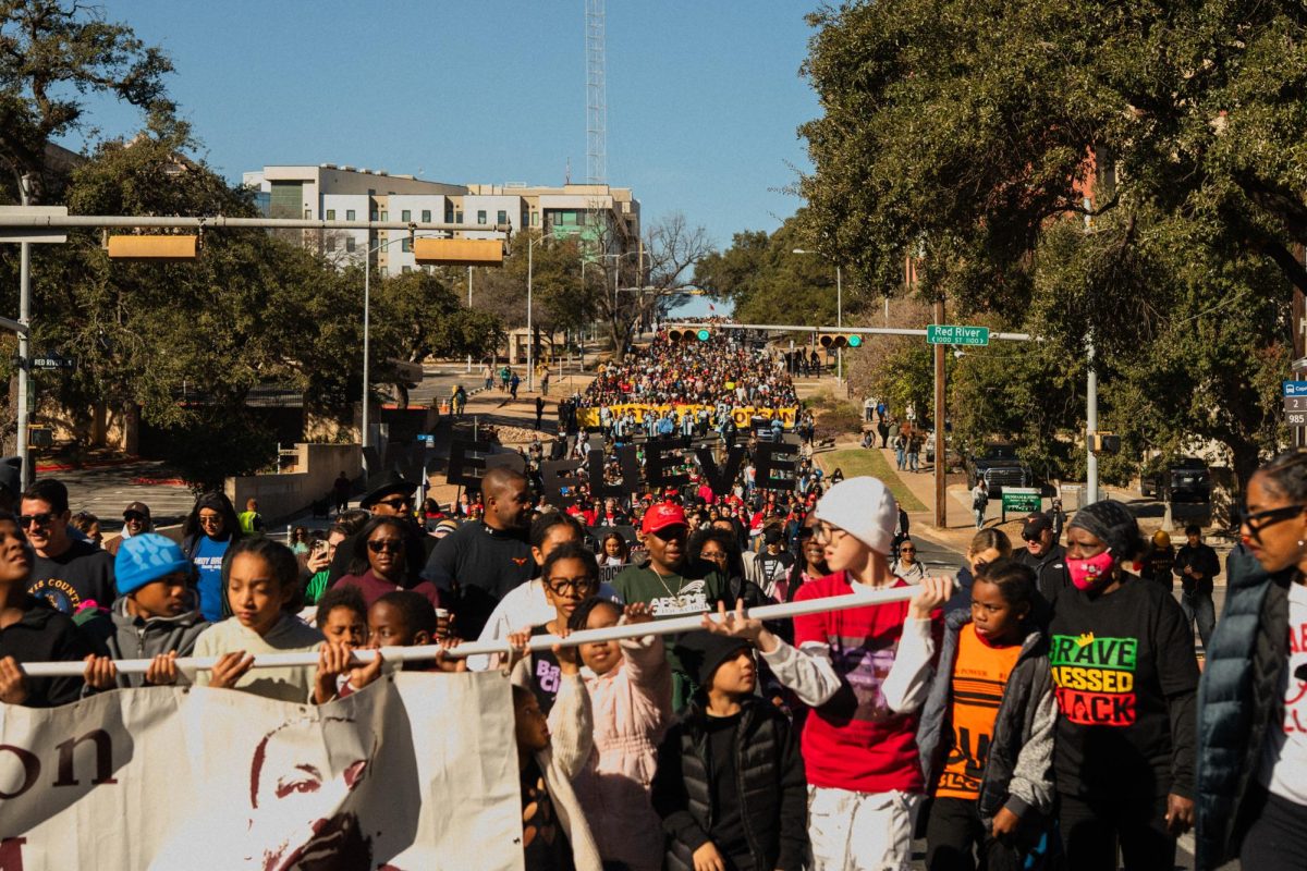 Marchers walk along 11th Street during the Dr. Martin Luther King Jr. parade on Jan. 19.