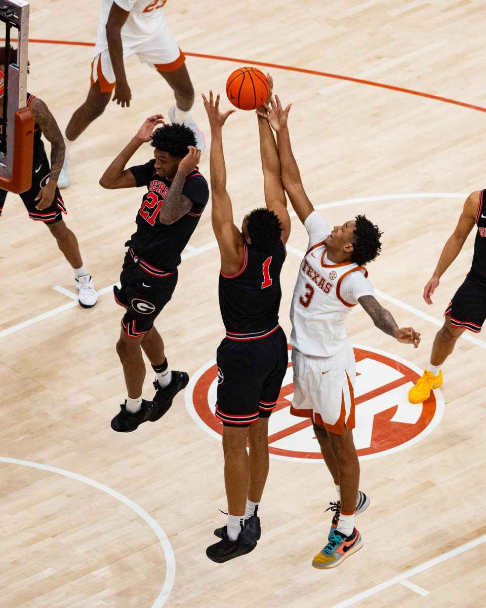 #1 Georgia forward Kareem Stagg and Texas forward Dailyn Swain reach for a rebound during Texas' game on Saturday, Jan. 24. 
