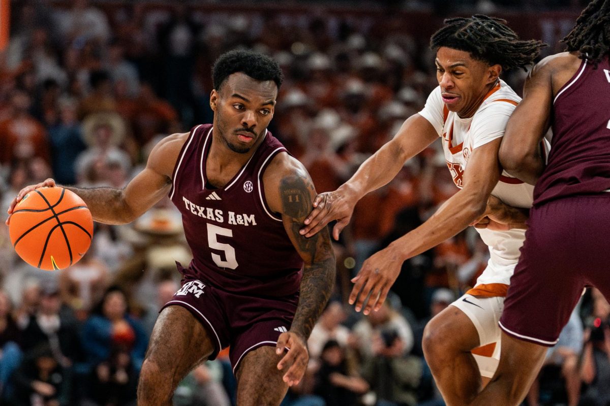 Texas guard Simeon Wilcher defends Texas A&M guard Jacari Lane on Saturday, Jan. 17. 
