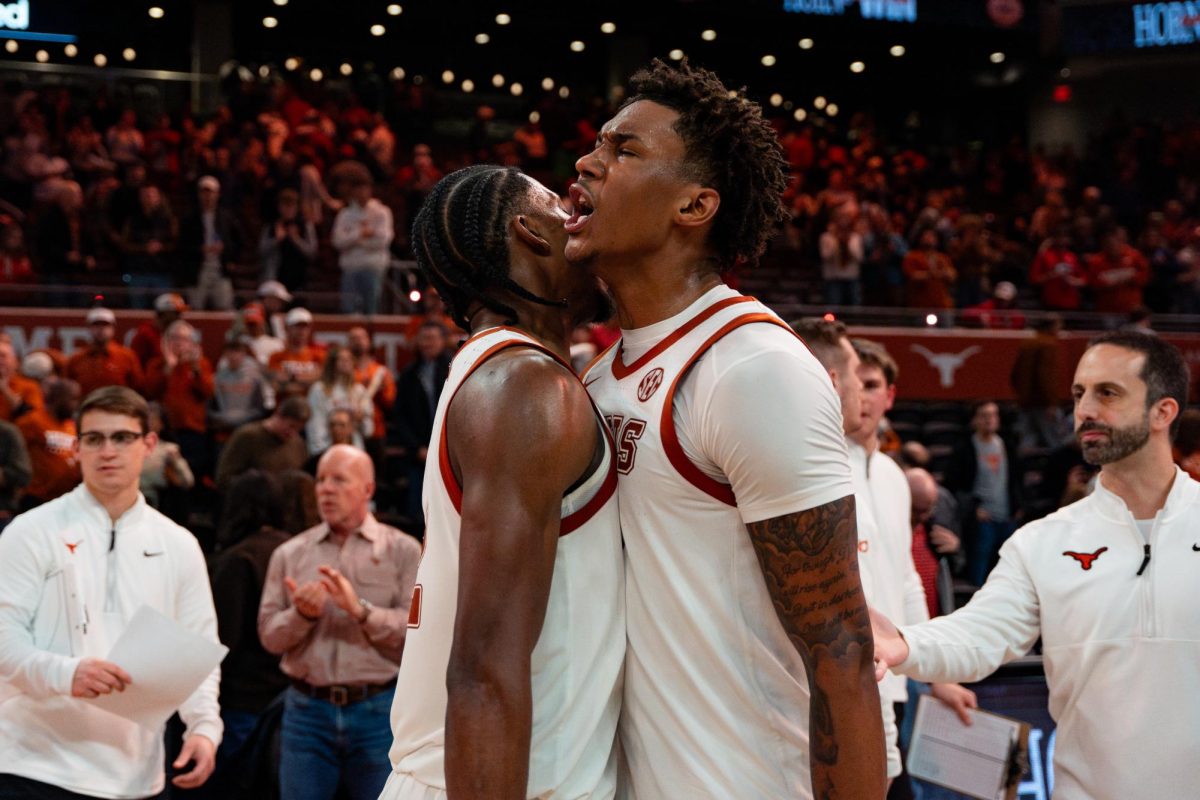 Forward Dailyn Swain (right) chest-bumps guard Tramon Mark (left) after Texas' win against Georgia on Saturday, Jan. 24. 