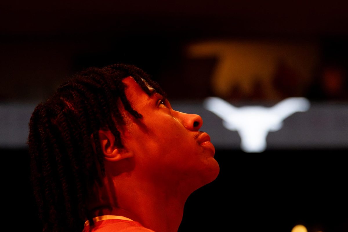 Junior guard Simeon Wilcher watches the Moody Center jumbotron ahead of a game against Ole Miss on Saturday, Feb. 7.