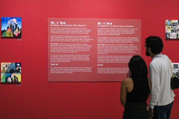 Two people read the description of the Mix 'n' Mash exhibit at the Mexic-Arte Museum on Feb. 16.