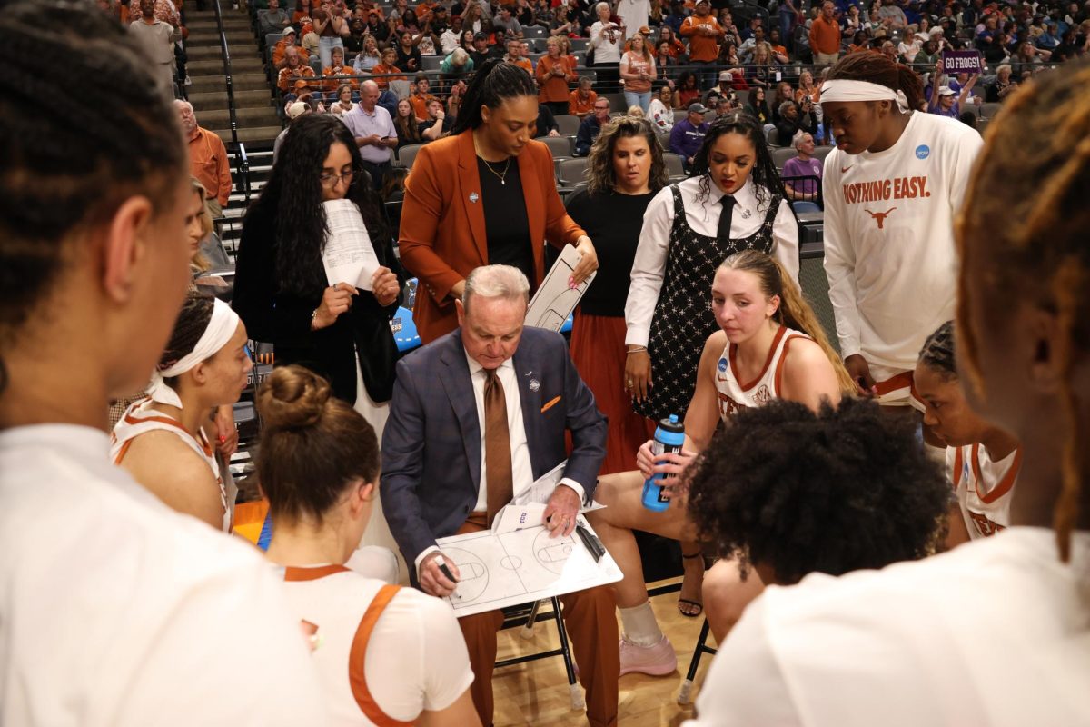 Texas women's basketball head coach Vic Schaefer talks to his team during the NCAA March Madness Elite Eight game against TCU in Birmingham, Ala., on March 31, 2025.