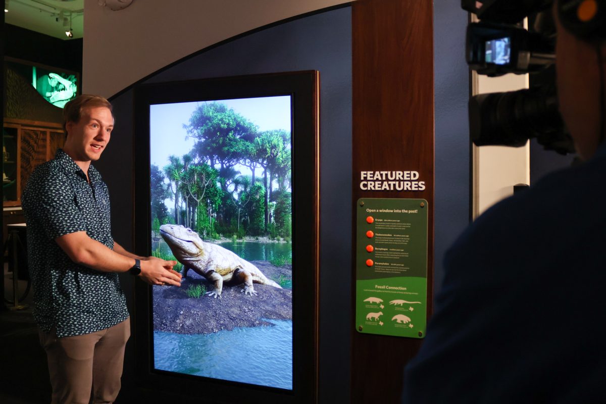 Exhibition and Outreach Associate Liam Norris explains Featured Creatures, a new digital installation at the Texas Science and Natural History Museum on Feb. 2. The installation will allow visitors to view how these extinct animals may have looked, sounded and behaved in their natural environment millions of years ago.