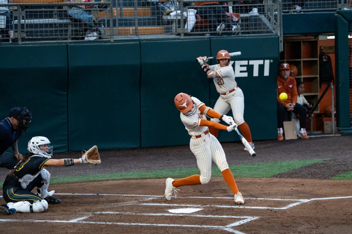 Catcher Reese Atwood hits the ball for a home run at the Texas softball game against Southeastern Louisiana at Charline & Red McCombs Field on Wednesday, Feb, 25. 