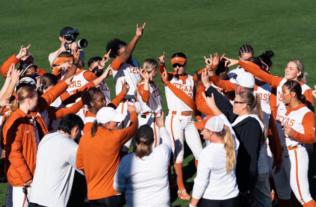 Texas softball players celebrate after winning 9-1 against Northern Illinois University on Sunday, Feb. 15.