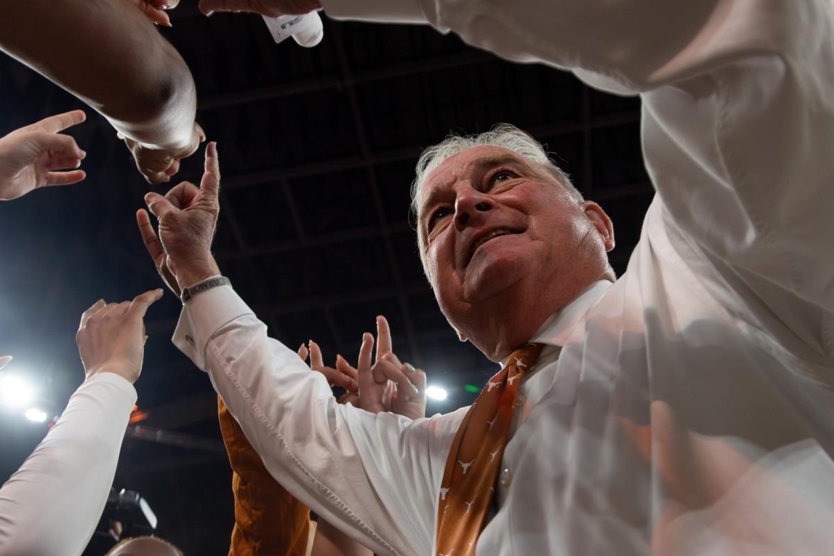 Head coach Vic Schaefer huddles up and congratulates the Texas women's basketball team after beating LSU 77-64 on Thursday, Feb. 5.