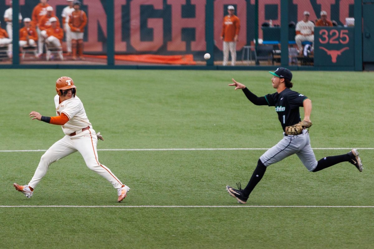 Junior infielder Ethan Mendoza is caught in a rundown between first and second base during the sixth inning at Texas' game against USC Upstate at Disch-Falk Field on March 8.