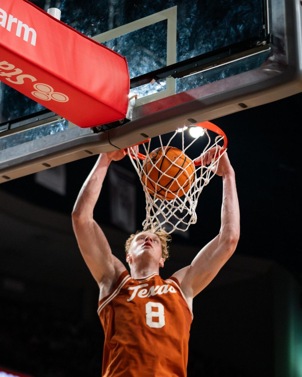 Texas center Matas Vokietaitis dunks the ball during the game against Texas A&M in College Station on Saturday, Feb. 28.
