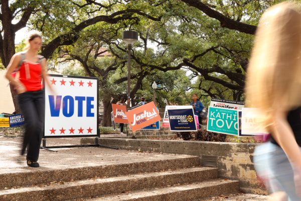 A "VOTE" sign and candidate posters for the Texas Primaries are pictured in front of the Texas Union on Monday, March 2.