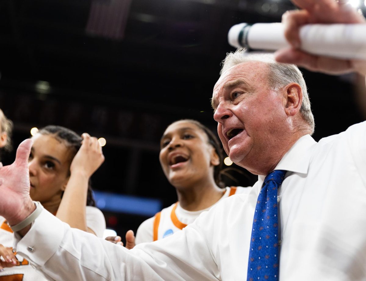 Texas coach Vic Schaefer speaks to the Longhorns in a huddle after winning the second round of the NCAA Tournament against Oregon 100-58 at Moody Center on Sunday, March 22. 