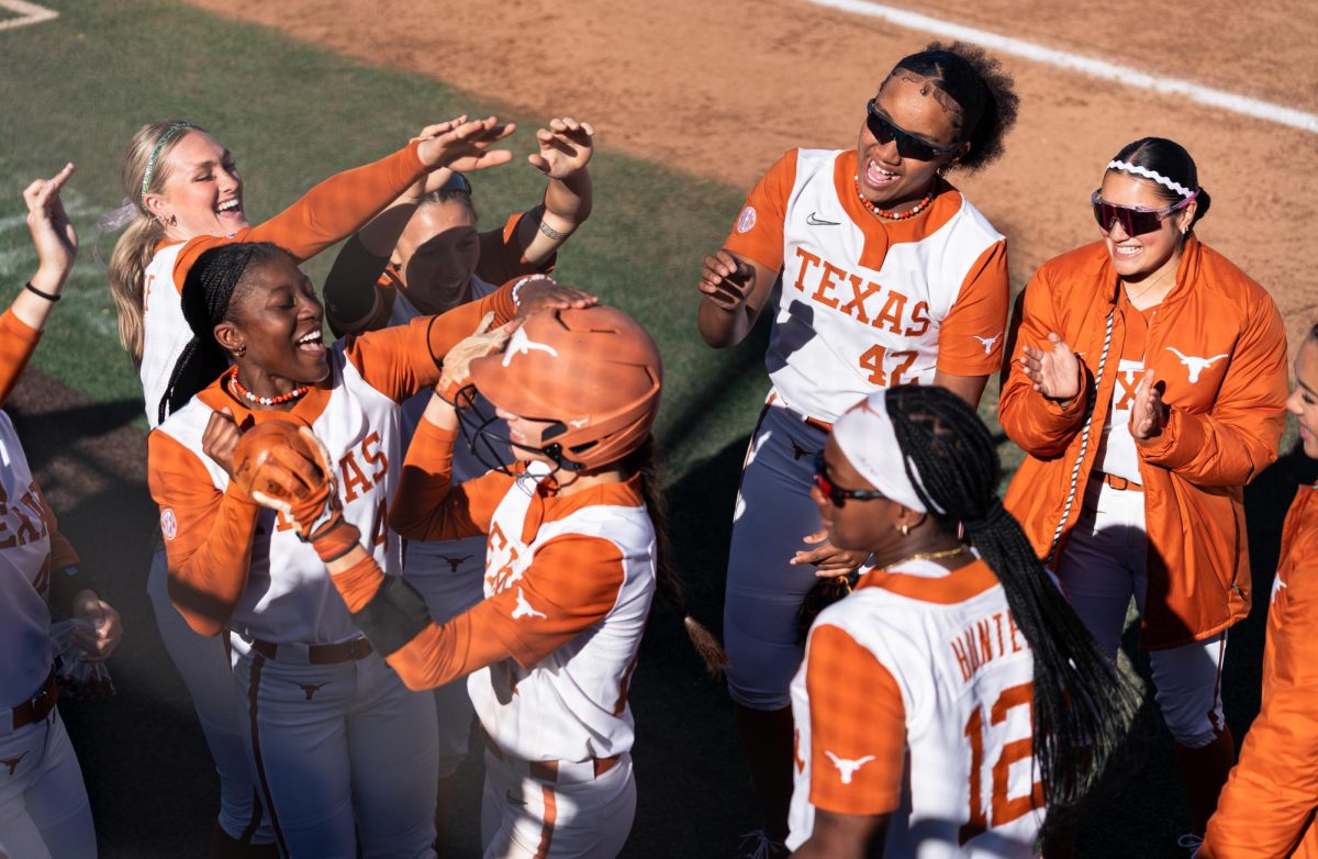 Texas players celebrate as freshman infielder Jaycie Nichols walks to the dugout after her first career home run at Texas' game against Northern Illinois University on Feb. 15.