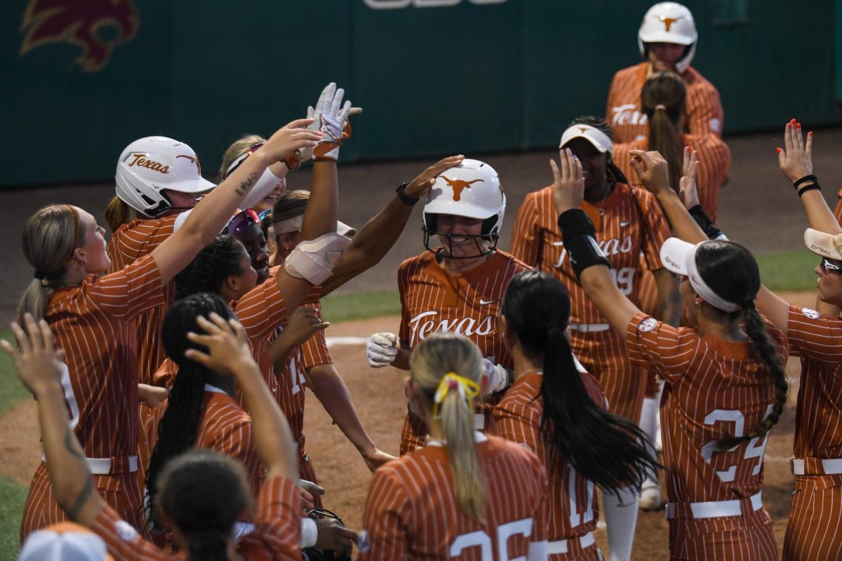 Texas softball celebrates senior catcher Reese Atwood after hitting a home run against Texas State at Bobcat Softball Stadium on March 25. 