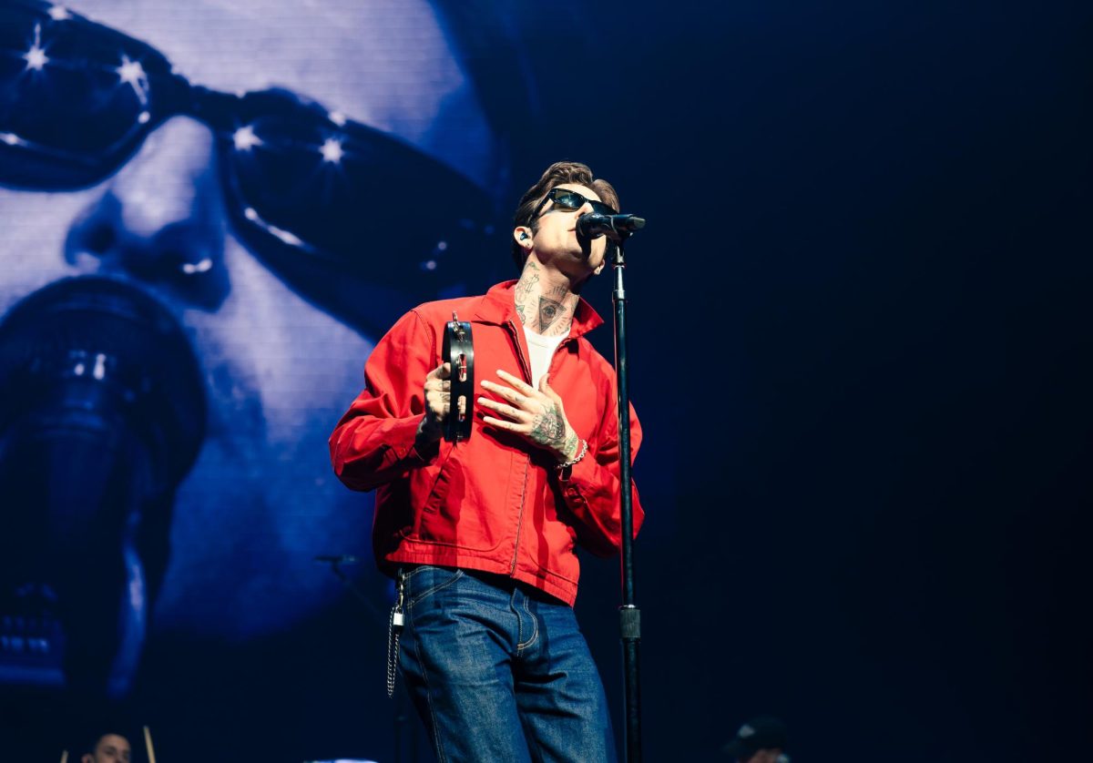 Jesse Rutherford, lead singer of The Neighbourhood, holds up a tambourine as he performs at Moody Center on March 28. Austin was the first stop on the band's THE WOURLD TOUR. 