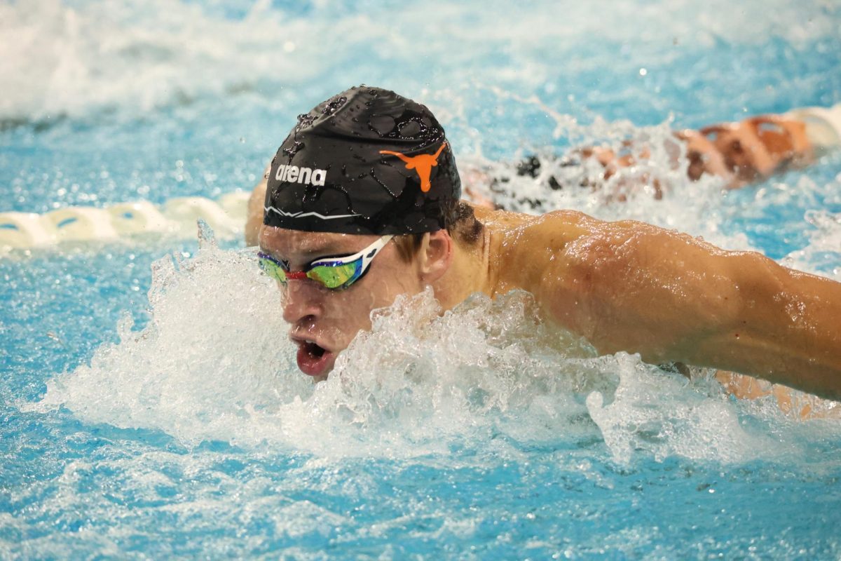 Will Modglin comes up for air as he races in the men's 100 fly timed trials at the swim meet against Tennessee on Oct. 26. 