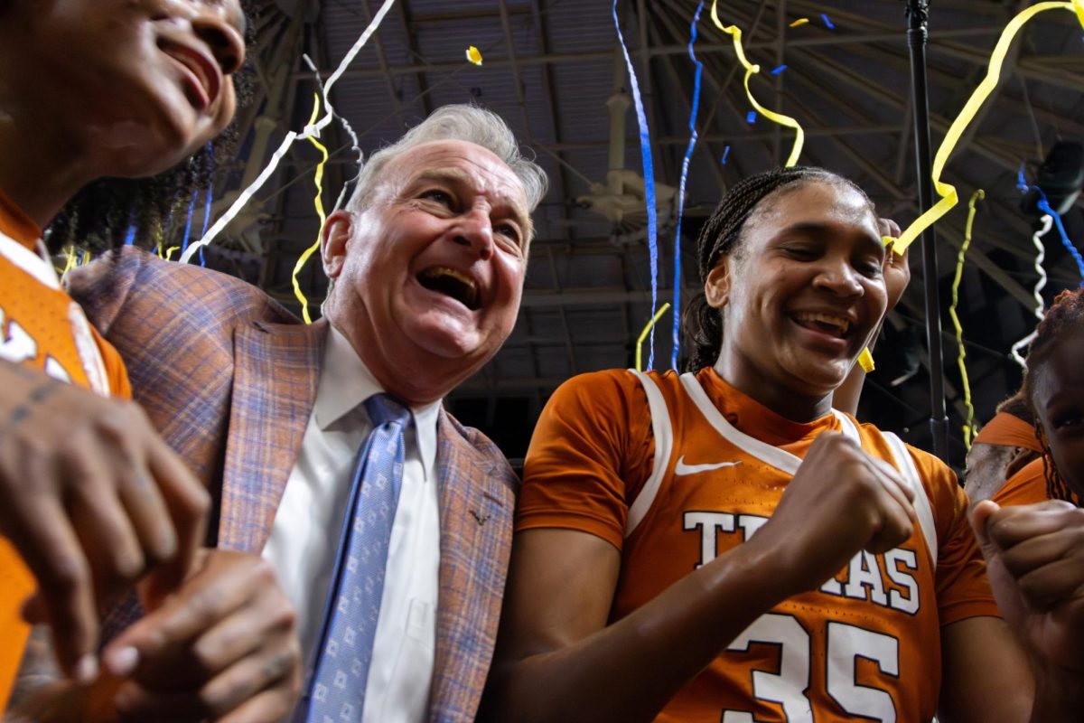 Head coach Vic Schaefer and junior guard forward Madison Booker smile as streamers fall after the Longhorns defeated the Gamecocks in the Southeastern Conference Championship game on Sunday, March 8.