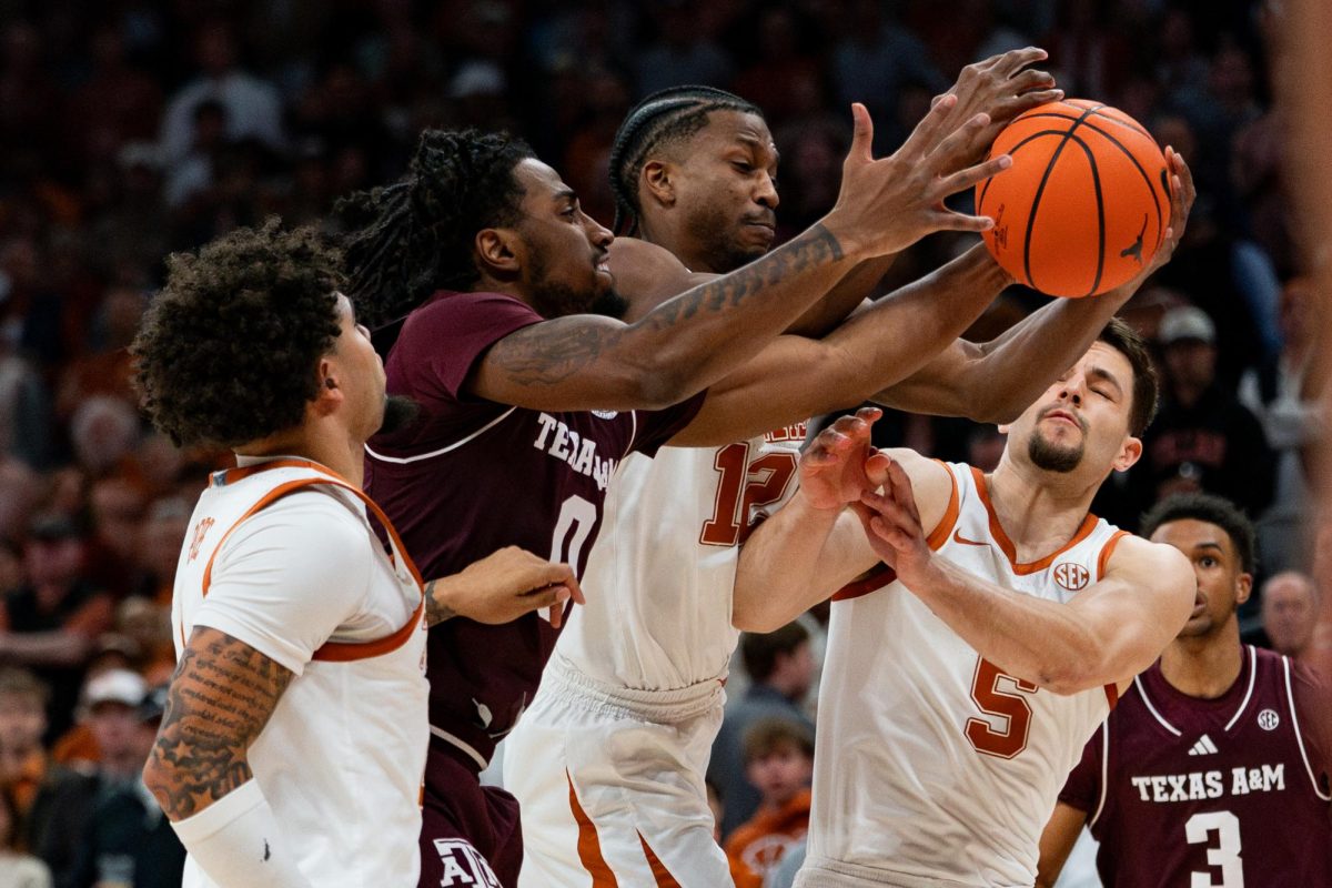 Texas A&M guard Marcus Hill and Texas guard Tramon Mark fight for a rebound on Jan. 17.