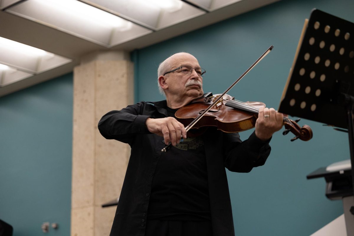 Professor Michael Domjan passionately performs the music of J. S. Bach in the lobby of the Perry Castañeda Library on March 24, 2026.