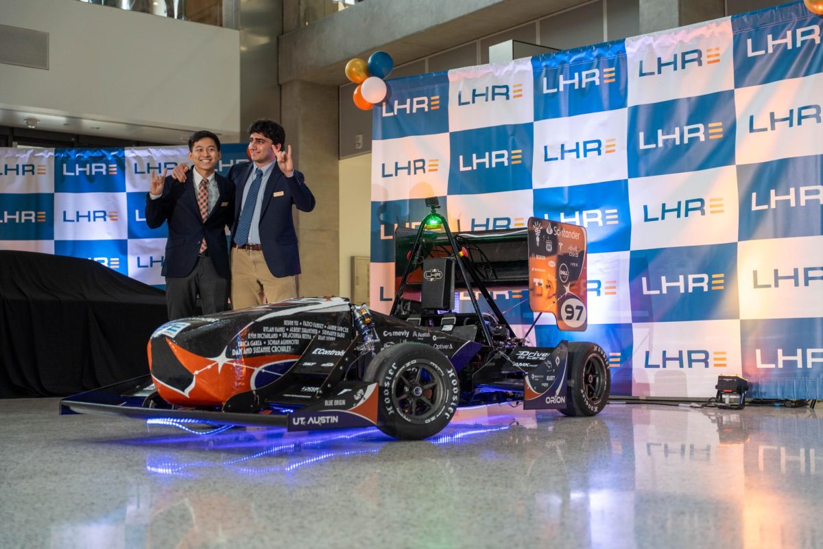 Team captain Tyler Yan (left) and chief engineer Matthew Mekha (right) unveil their electric team's vehicle at the Longhorn Racing annual event at the Engineering Education and Research Center on April 18, 2026.