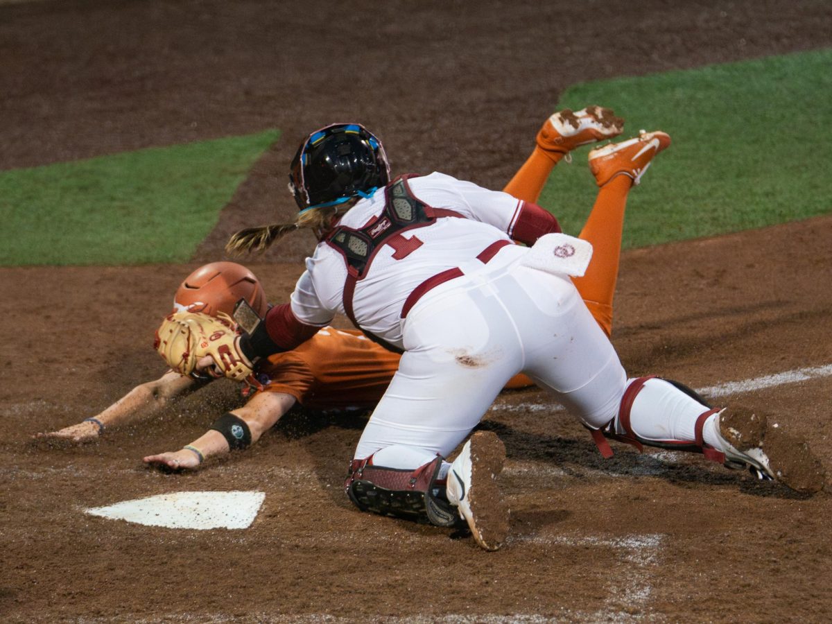 Catcher Kendall Wells tags out senior Ashton Maloney at home plate against the Oklahoma Sooners on April 10, 2026.