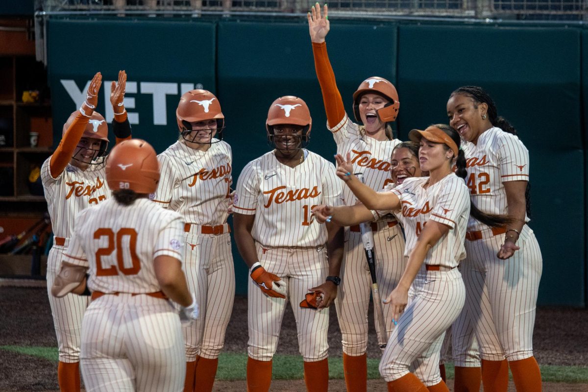 Texas softball gathers at home plate to celebrate junior catcher Katie Stewart’s grand slam against East Texas A&M on Wednesday, March 11 at Red & Charline McCombs Field.