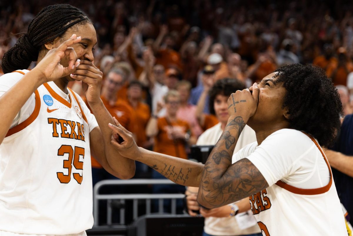 Texas junior front Madison Booker, left, and senior guard Rori Harmon laugh during The Eyes of Texas at Moody Center on March 22.